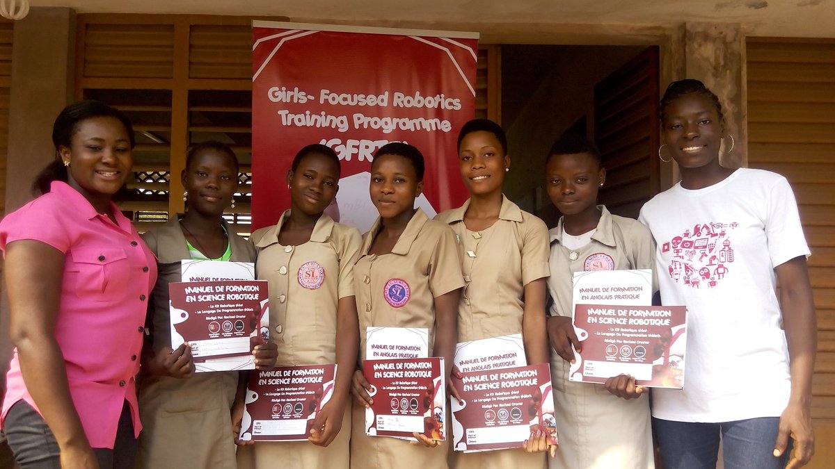 Students holding robotics training manuals during a FemCoders programme in Benin